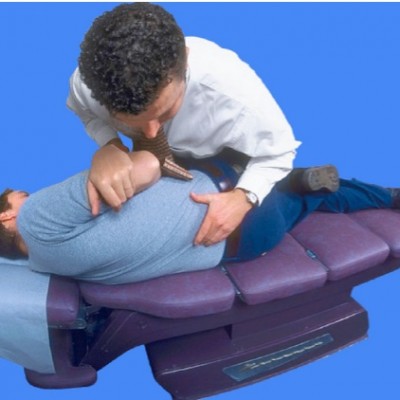 chiropractor adjusting spine in chair